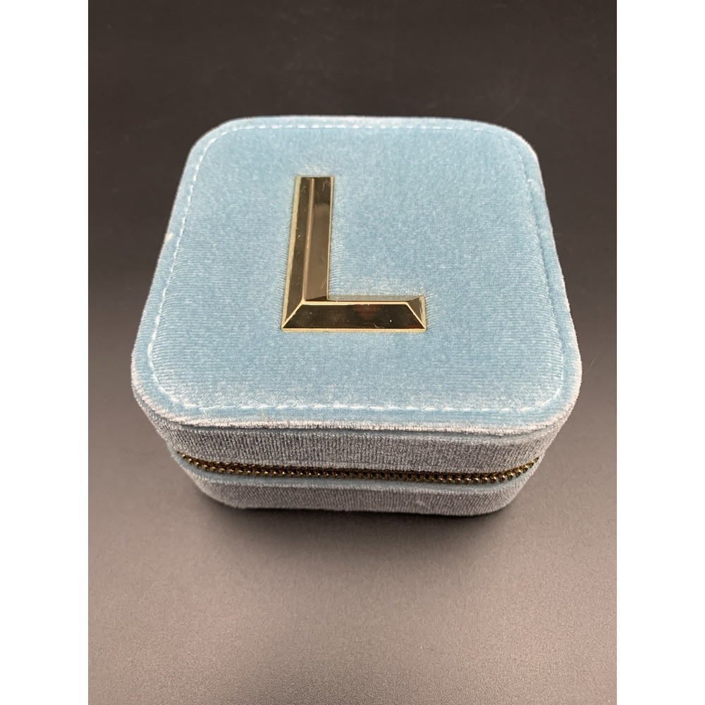 Small blue velvet jewelry box with a zipper
